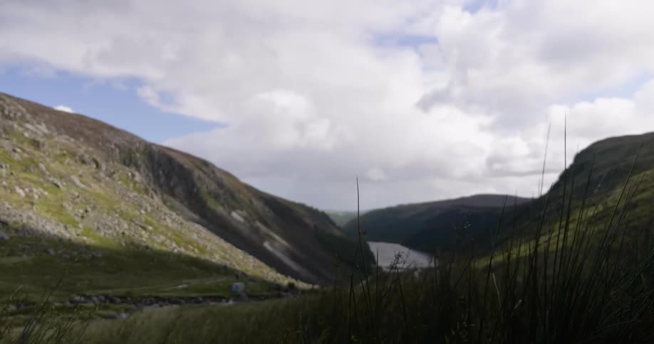 A river at the base of rolling hills