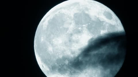 Close up view of the moon on a partly cloudy night