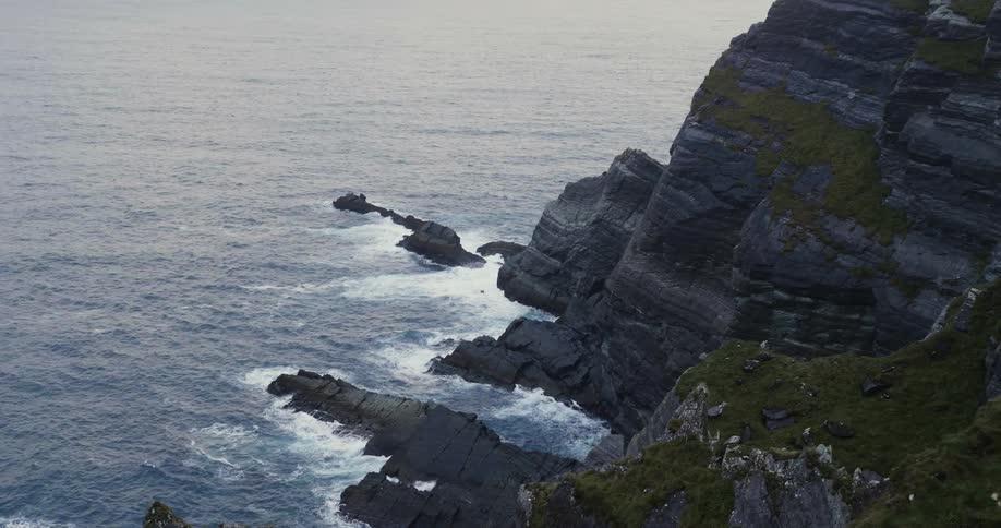 Waves crash against a rocky shore