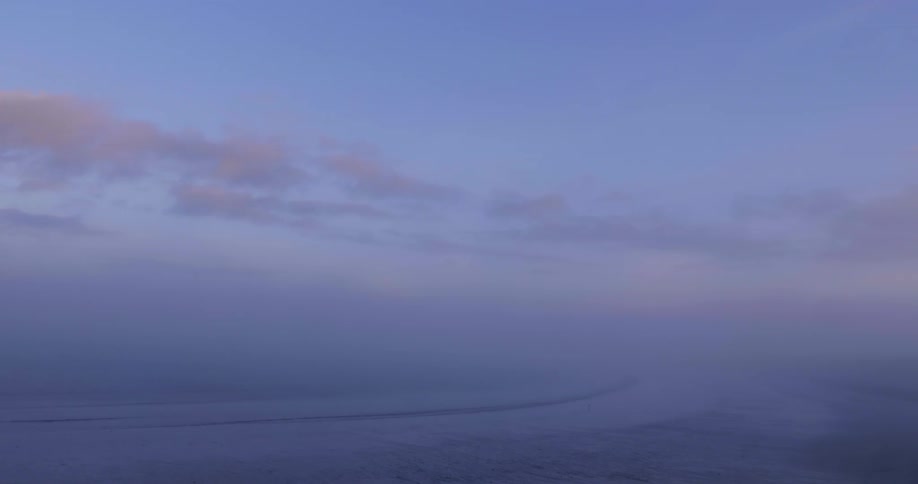 A view of water coming in and the skies looking cloudy