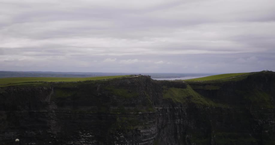 Tall mountains are flat at the top and covered with green