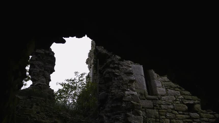 Under the stone is a tower with a window