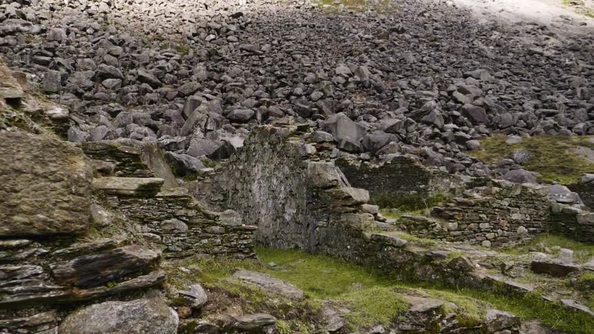 The hills are covered with destroyed stone walls