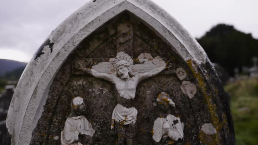 A statue of jesus is engraved in stone