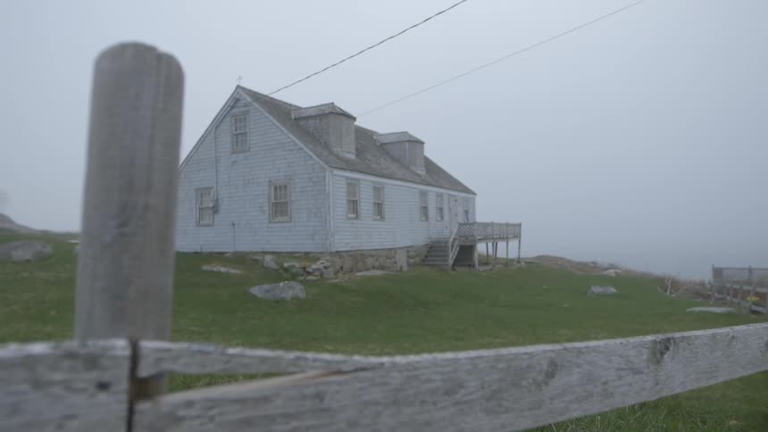 Lone house surrounded by an old wood fence