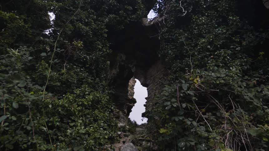 The stone wall has a hole in the middle