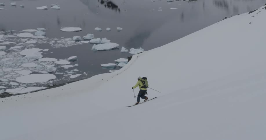 Person telemark skiing down a steep slope in Antarctica