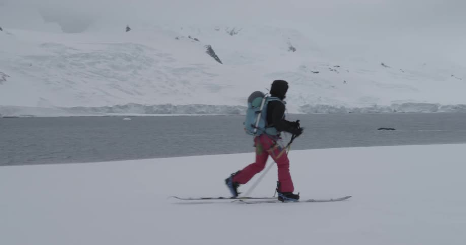 Person on skis walks fast on flat snow
