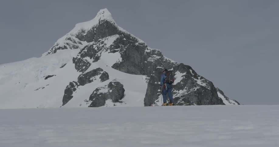 Man skinning up snowy mountain