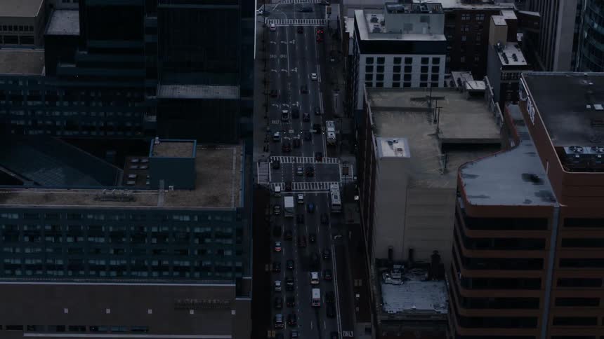 Cars drive on a city street
