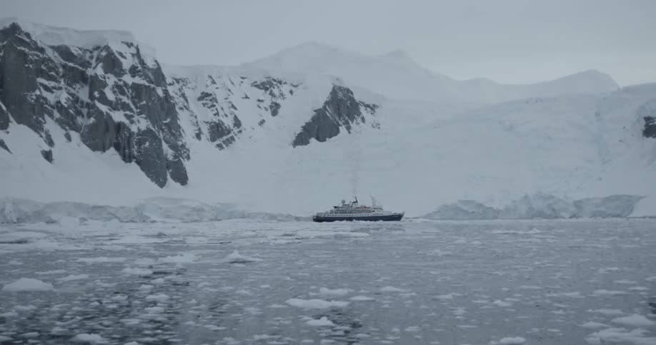 A ship moves slowly through sea ice