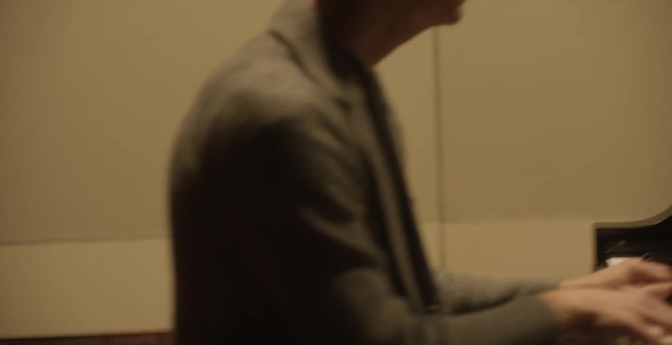 A man is playing the piano