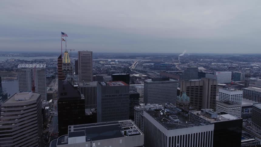 The rooftops of a city skyline under a cloudy sky