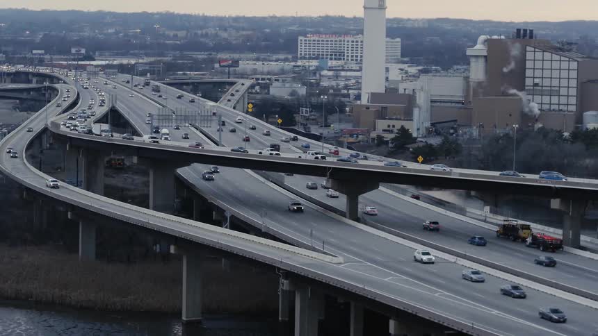 The raises highway has cars traveling away from the city