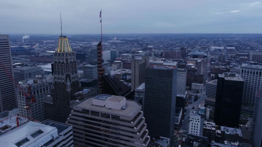 Flag flying on top of a building in a large city