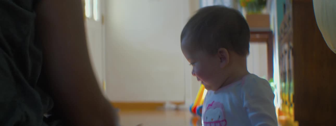 A baby is playing with their parent