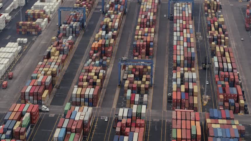Aerial view of different colored boxes piled in a large yard