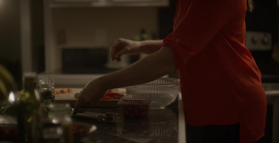 A woman is preparing food in the kitchen
