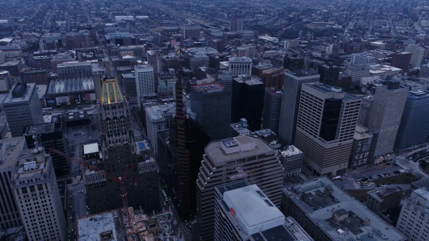 The large city has many tall buildings at sunset