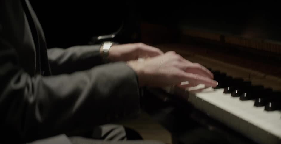 A man playing a piano in a room