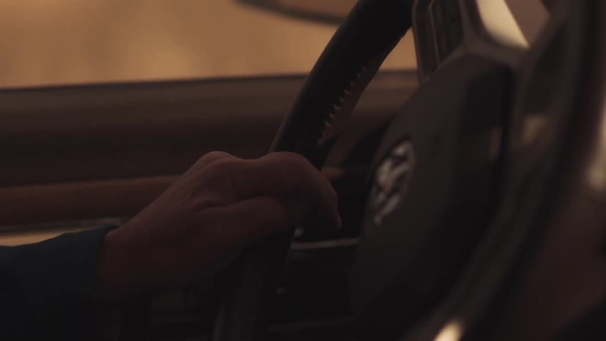 A person is steering their car