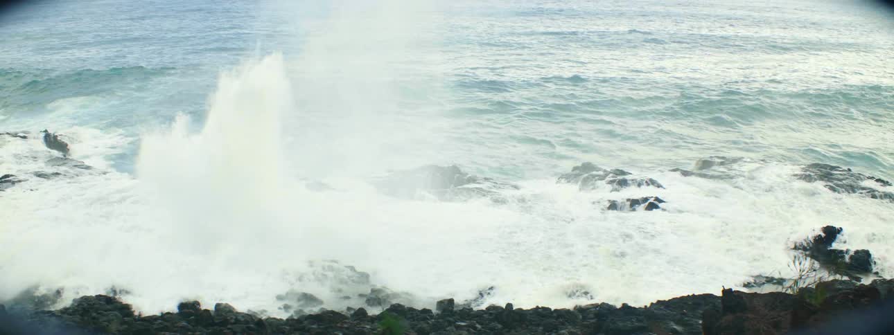 Waves crash into the rocky shoreline