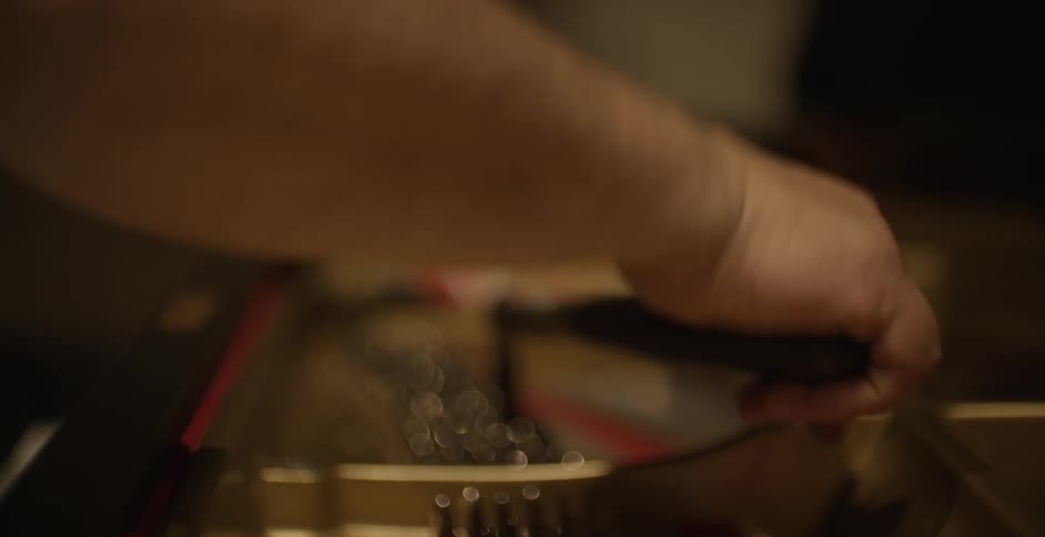 A man tunes a piano
