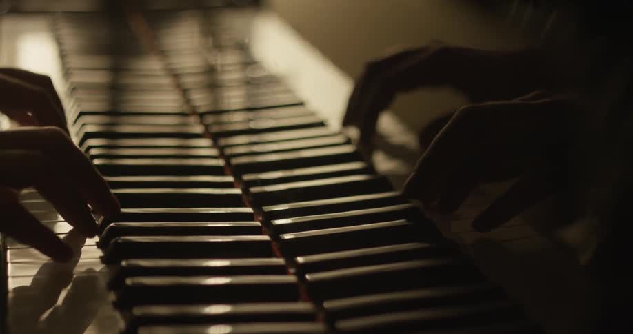 A person slowly plays the piano