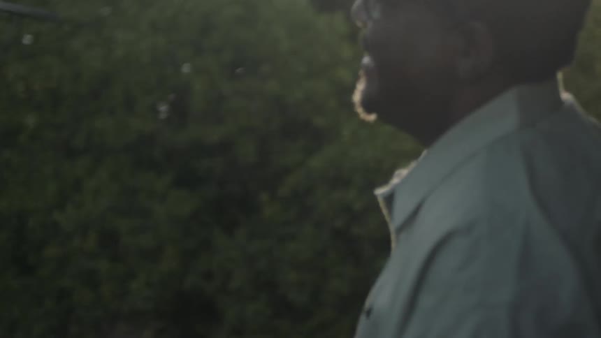 A man holding a phone smiles before ending a call