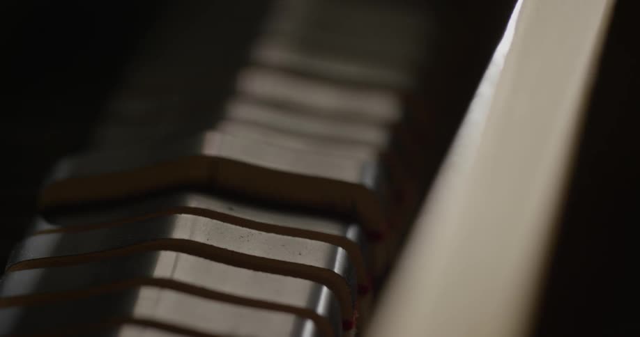 The inner workings of a piano are shown moving