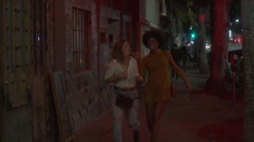 Two women laugh and have fun running