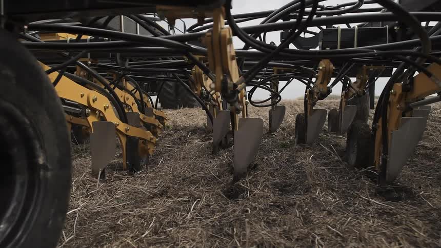 Close up of the bottom of a tractor plowing