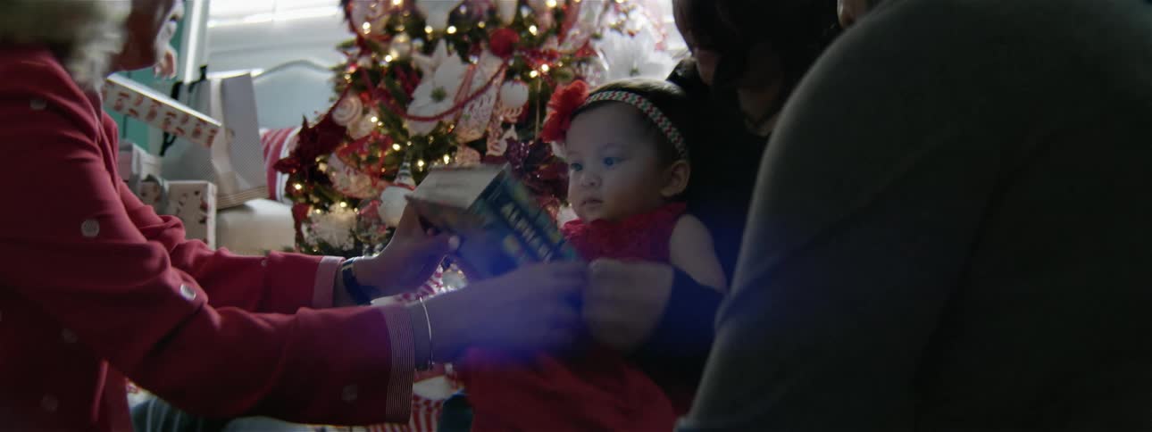 A woman flips through a book showing a baby