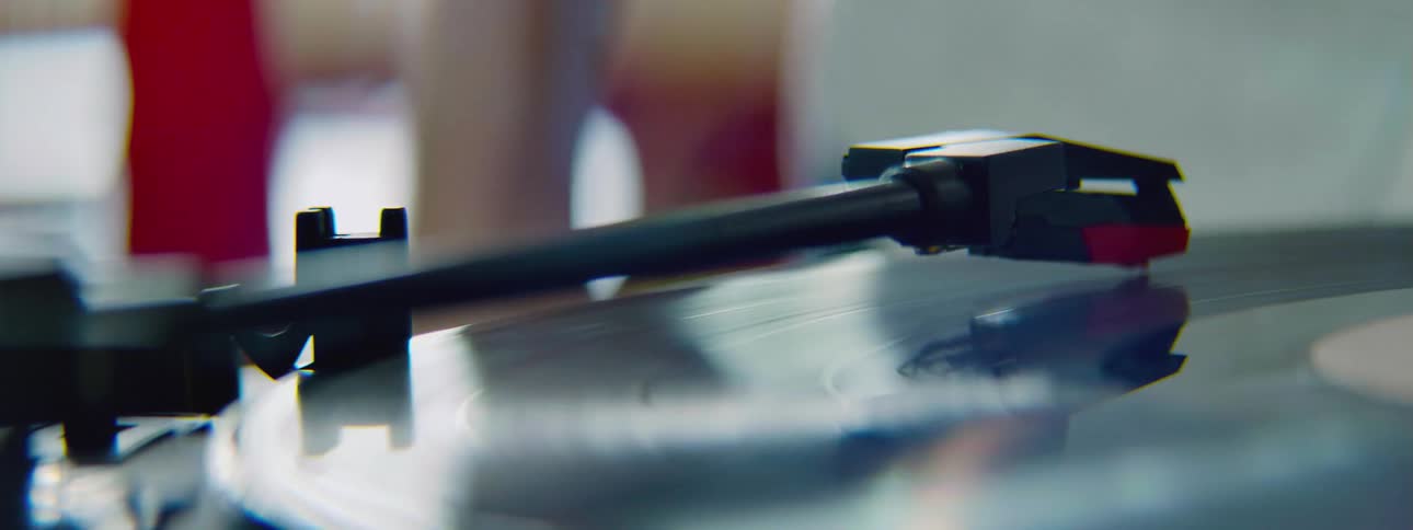 A person puts the needle on a record album
