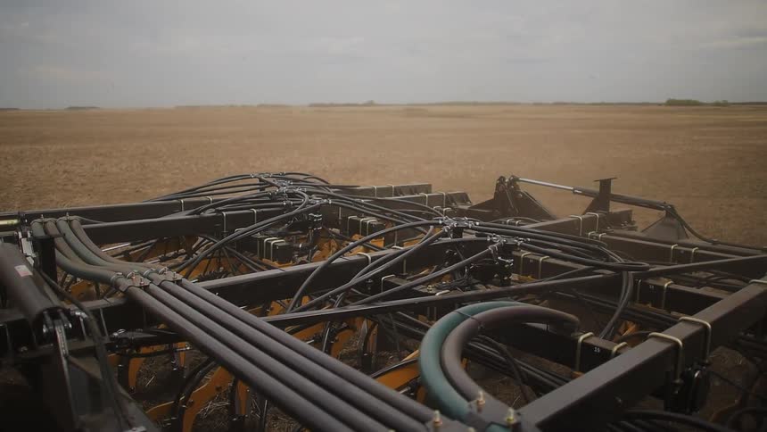 Tractor plowing up farmland on a cloudy day