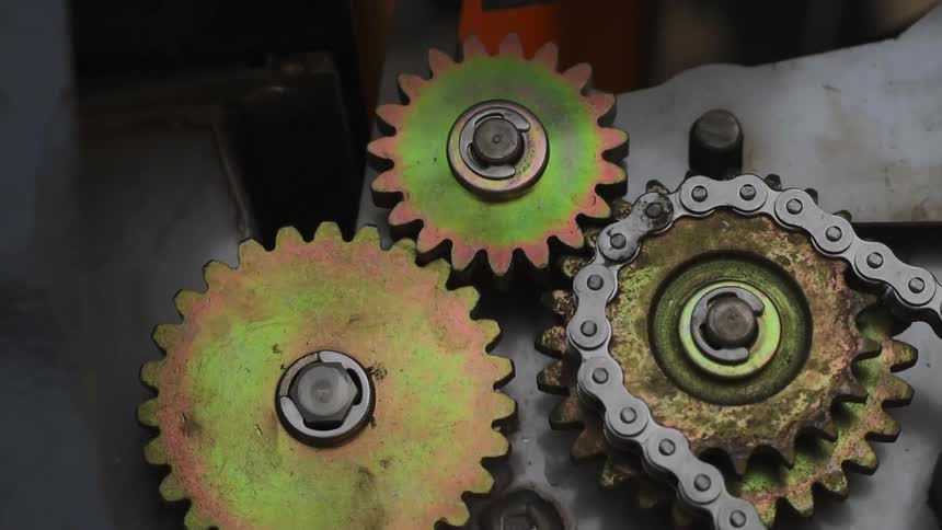 The gears turn pulling a chain