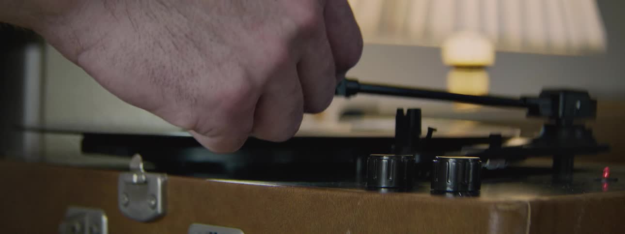 Record being placed on a record player with the needle put on it