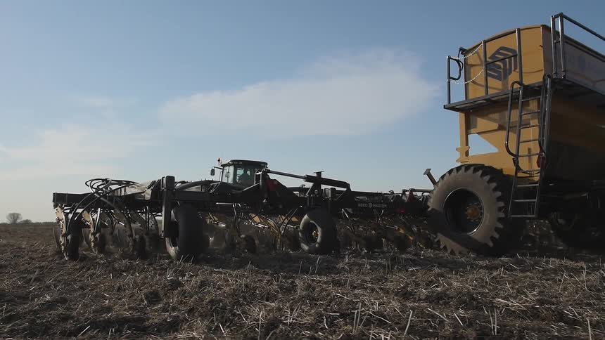 Large tractor plows a field
