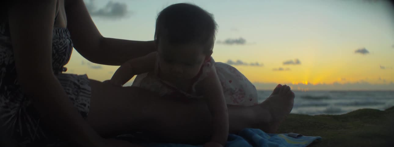 A baby is playing on the windy beach