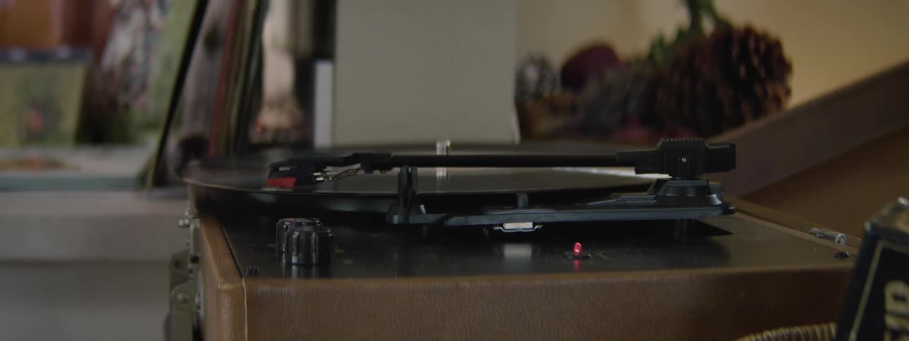 A person turns on a record player