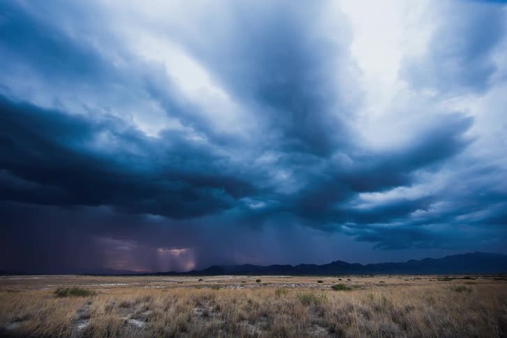 The storm clouds spin with rain and lightning shooting out from them
