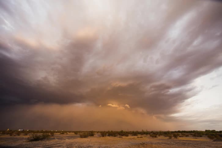 The town in the distance is covered with a huge storm