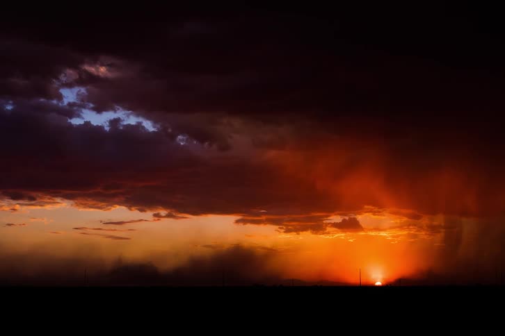 Clouds roll over an orange sky