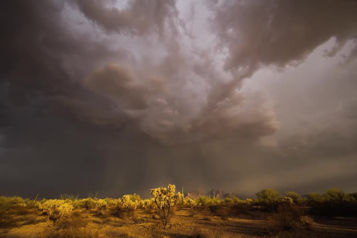 Large storm clouds move into the sky pouring rain
