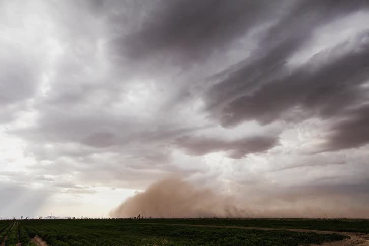 A sand storm moves over the field