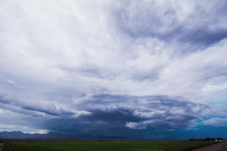 Large storm clouds spin in the skyline