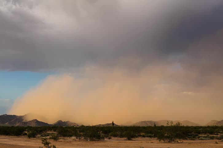Rain is pouring in the distance from a large cloud