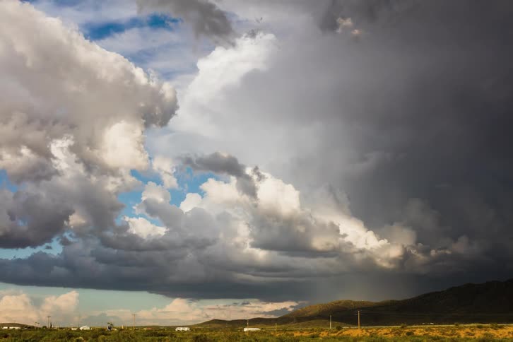 Large clouds move together across the landscape