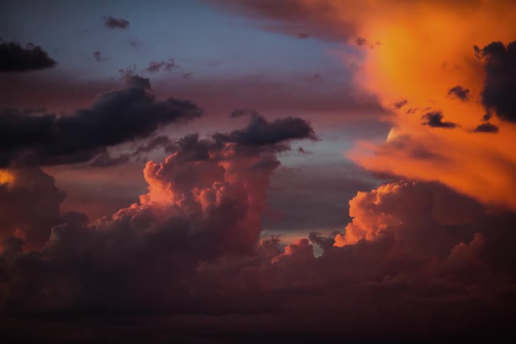 Clouds are tinged gold and pink from sunset