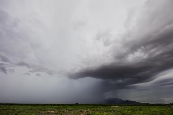 The white clouds from into a storm in the distance